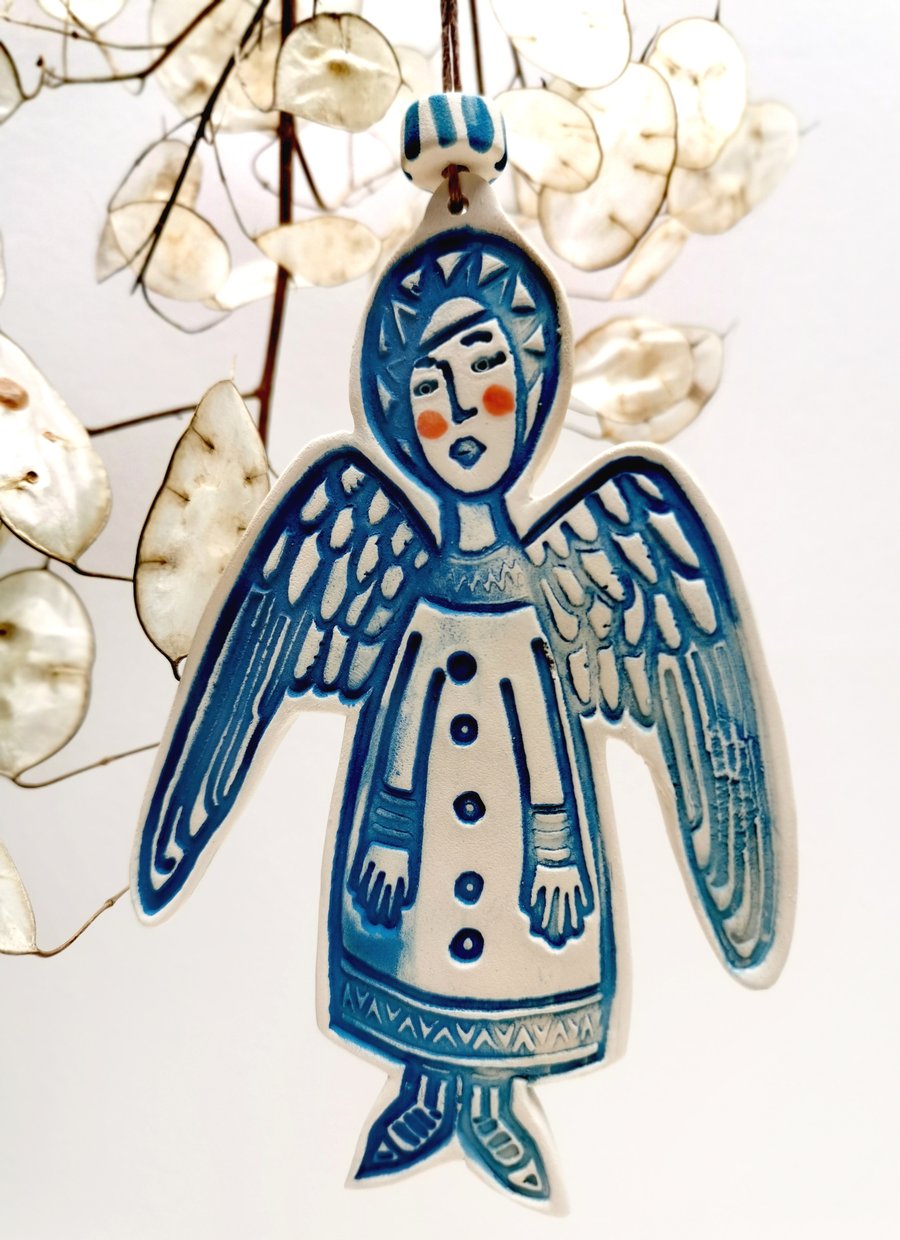 Ceramic Angel decoration in blue shadow