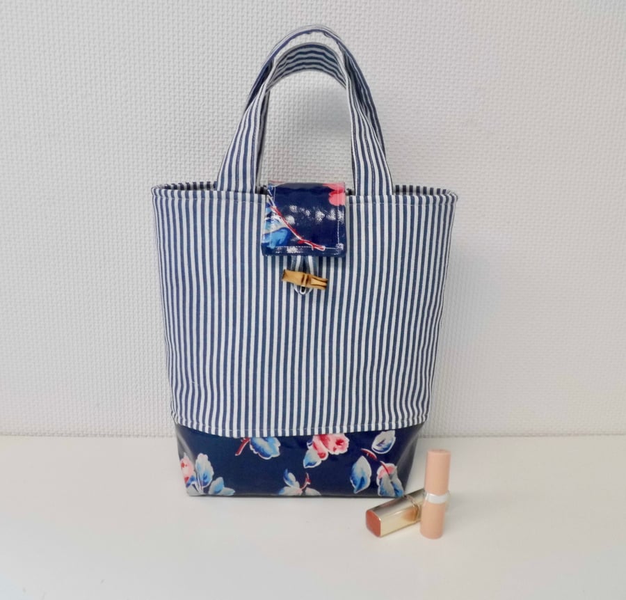 Hand bag in blue white striped fabric with navy floral oilcoth base small tote