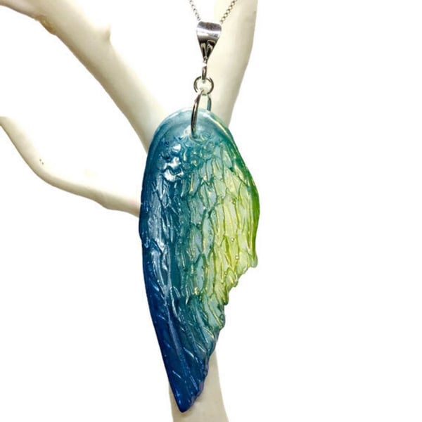 Blue green and yellow angel wing statement resin pendant on sterling silver.