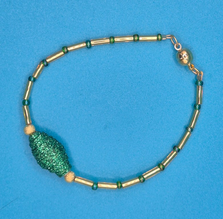 Delicate green and gold bracelet with sparkly paper bead