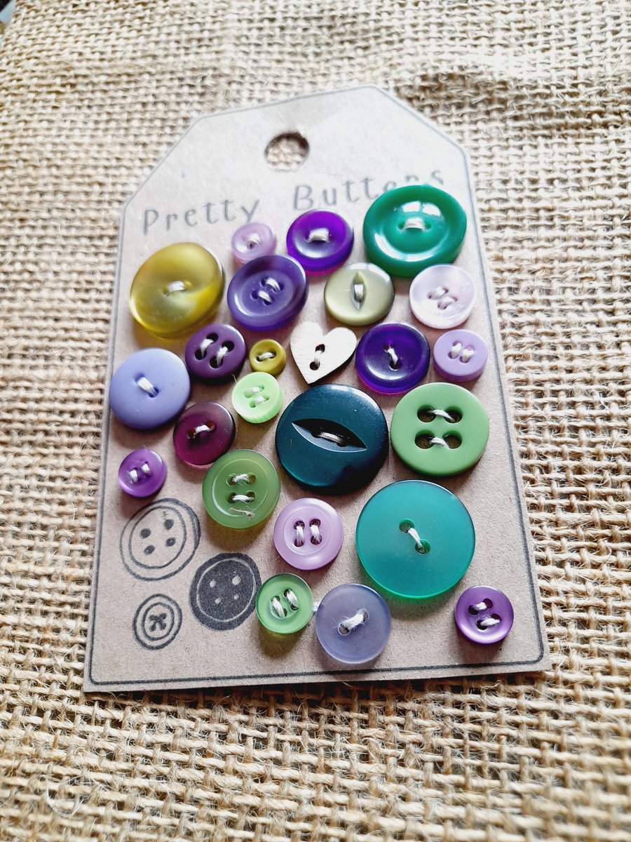 A curated collection of pretty vintage buttons in emerald and purple shades
