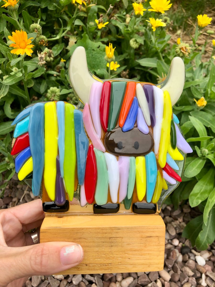 Gorgeous Fused glass Highland cow ornament each one unique on a wooden stand