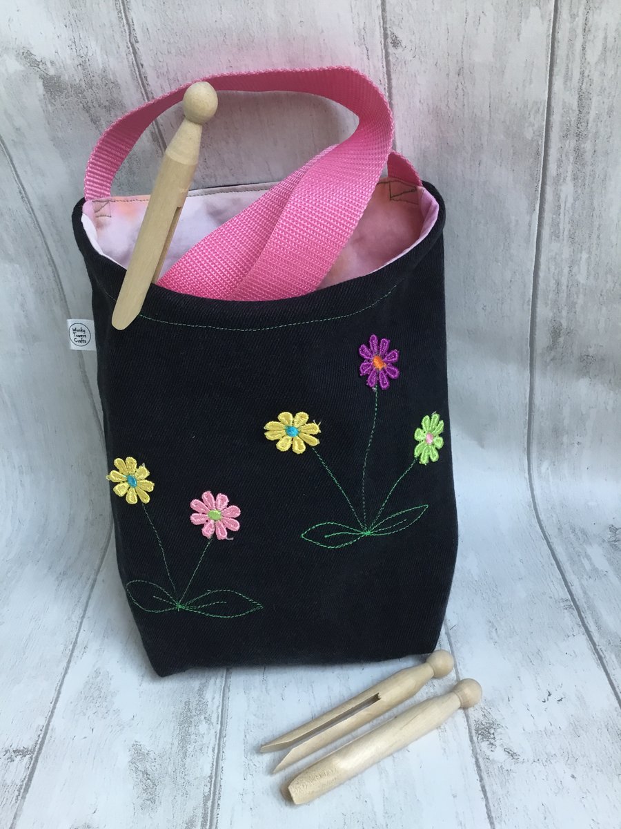 Cross-body peg bag. Repurposed black denim with floral decoration