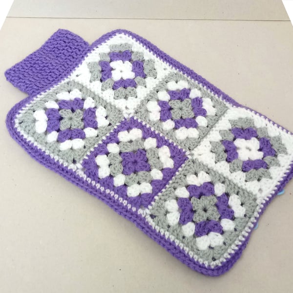 Hot water bottle cover in purple, white and grey.  