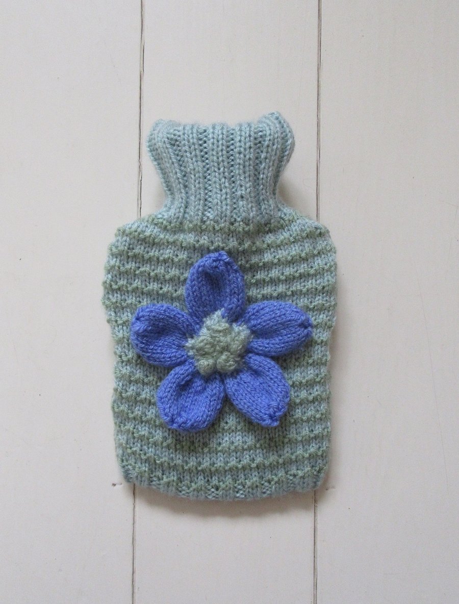 Hand knitted stripy hot water bottle cover with daisy flower
