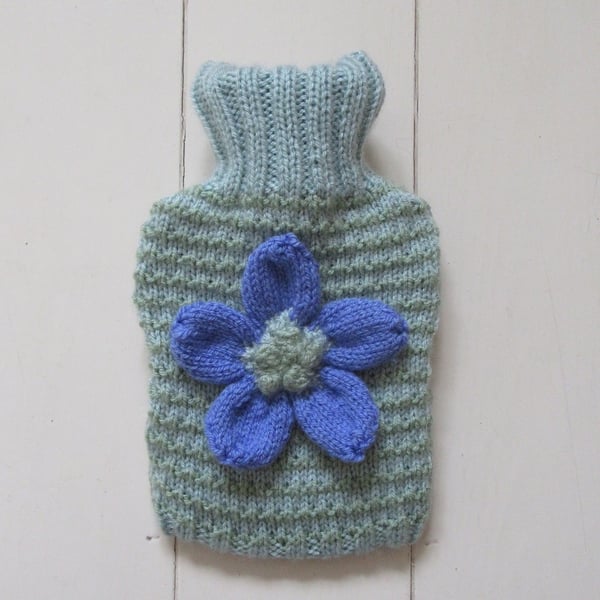 Hand knitted stripy hot water bottle cover with daisy flower