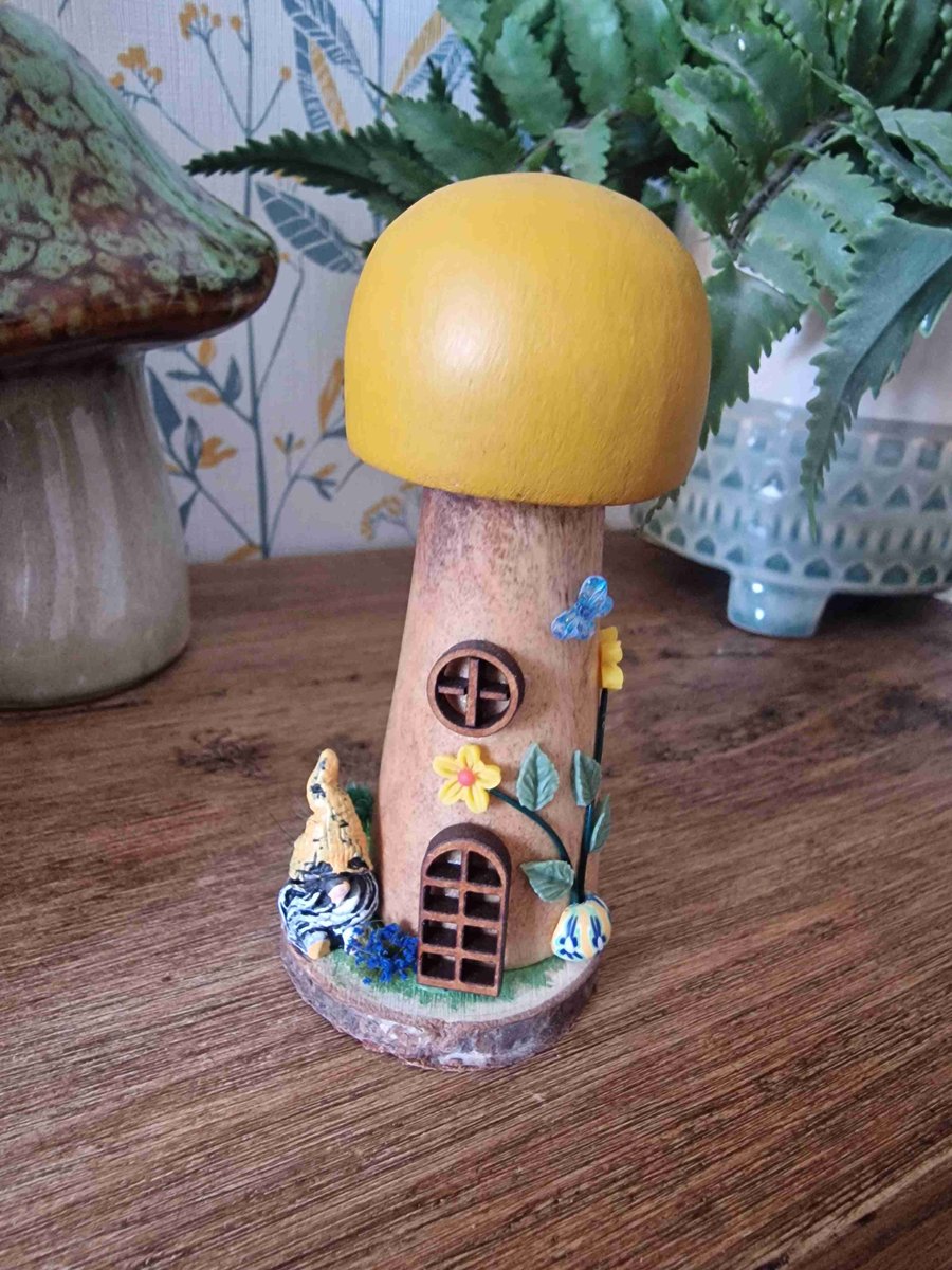 A Ocre Wooden mushroom on a wooden slice base. Featuring a gnome in the garden. 