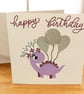Smiling Dinosaur Birthday Card – with a floral headbands and balloons 