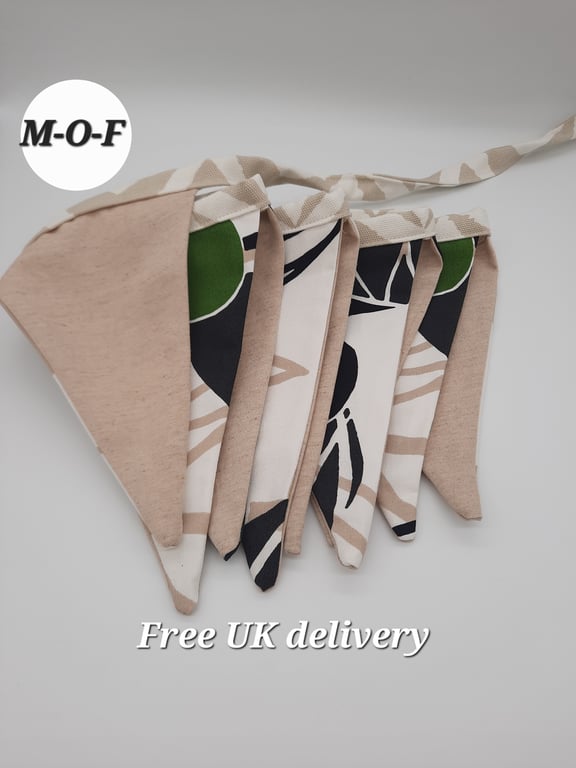 Bunting, 9 triangles of beige, white, black and green pattern fabric.  