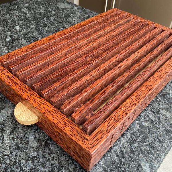 A premier coconut palm and oak crumb catcher bread board
