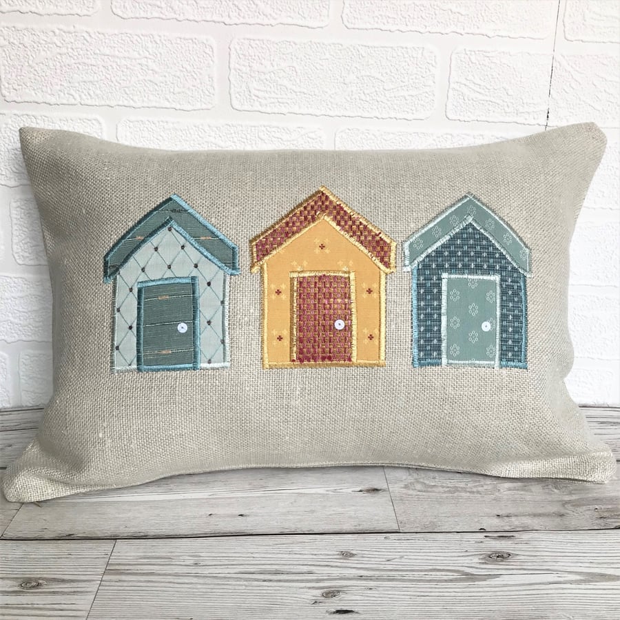 Beach huts cushion in cream with blue, golden-yellow and salmon huts