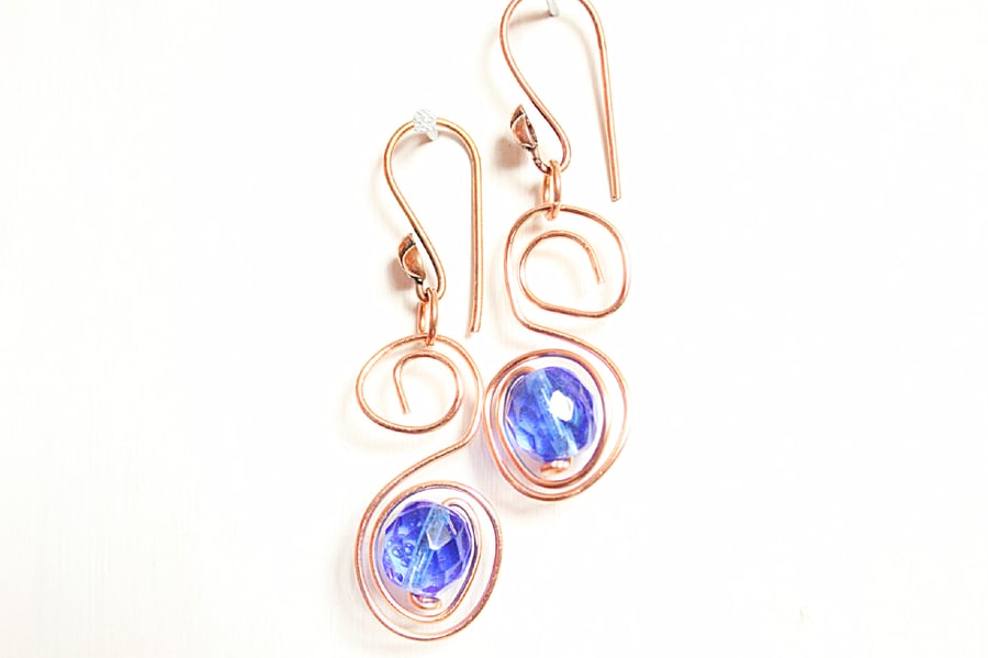 Dark blue faceted glass bead and copper S spiral dangle earrings