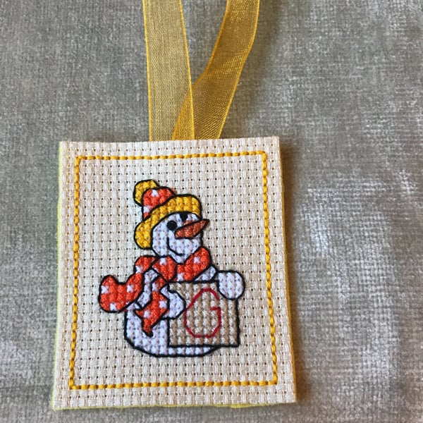 Cross stitched initial G snowman . Handmade Christmas tree decoration with a sno