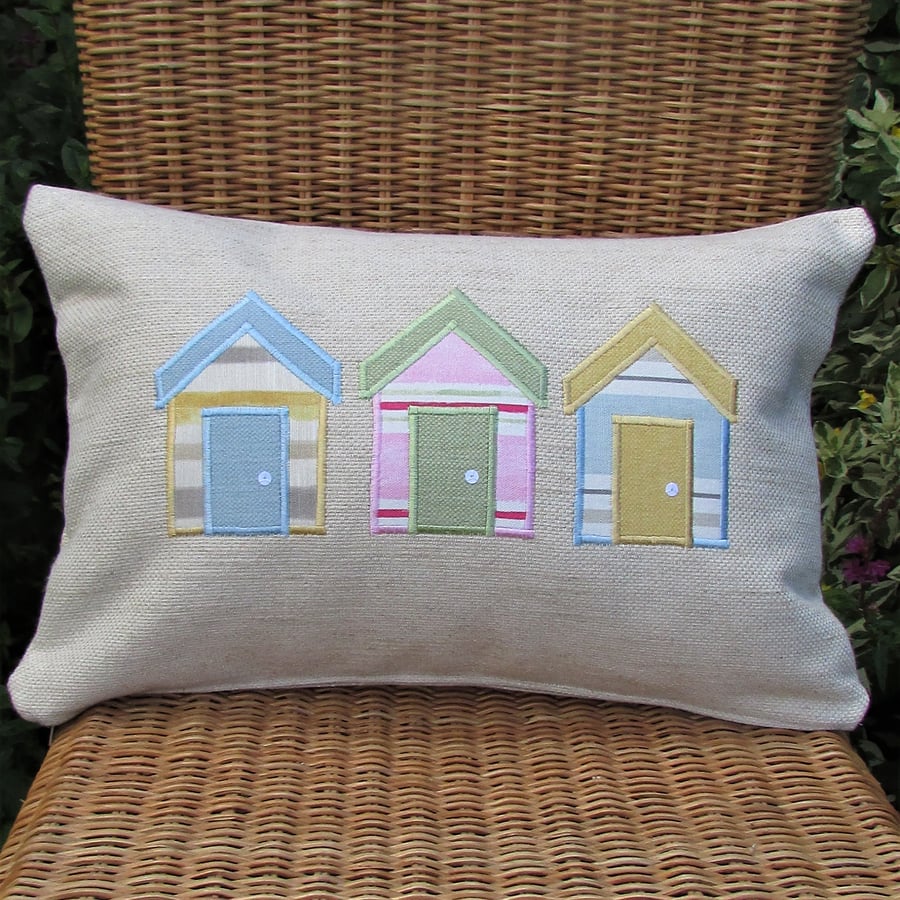 Beach huts cushion, rectangular, in cream with pastel blue, pink and yellow huts