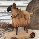 Primitive handmade sheep on wheels 