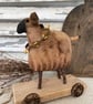 Primitive handmade sheep on wheels 