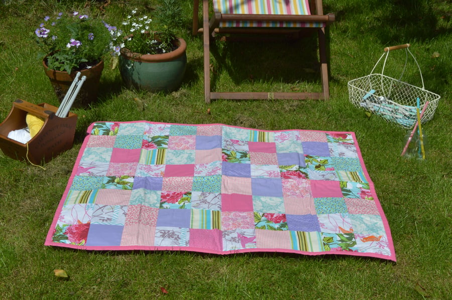 Pretty handmade patchwork picnic blanket, throw or quilt in pinks.