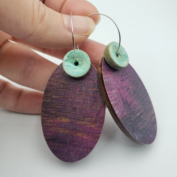 Oval shaped earrings in burgundy with a mint button bead