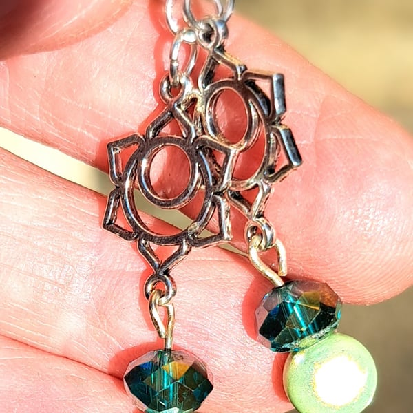 Lovely pair of dangle silver plated earrings, disco bead and the lotus flower