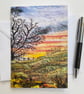 Sunrise over a hill with tree printed card.