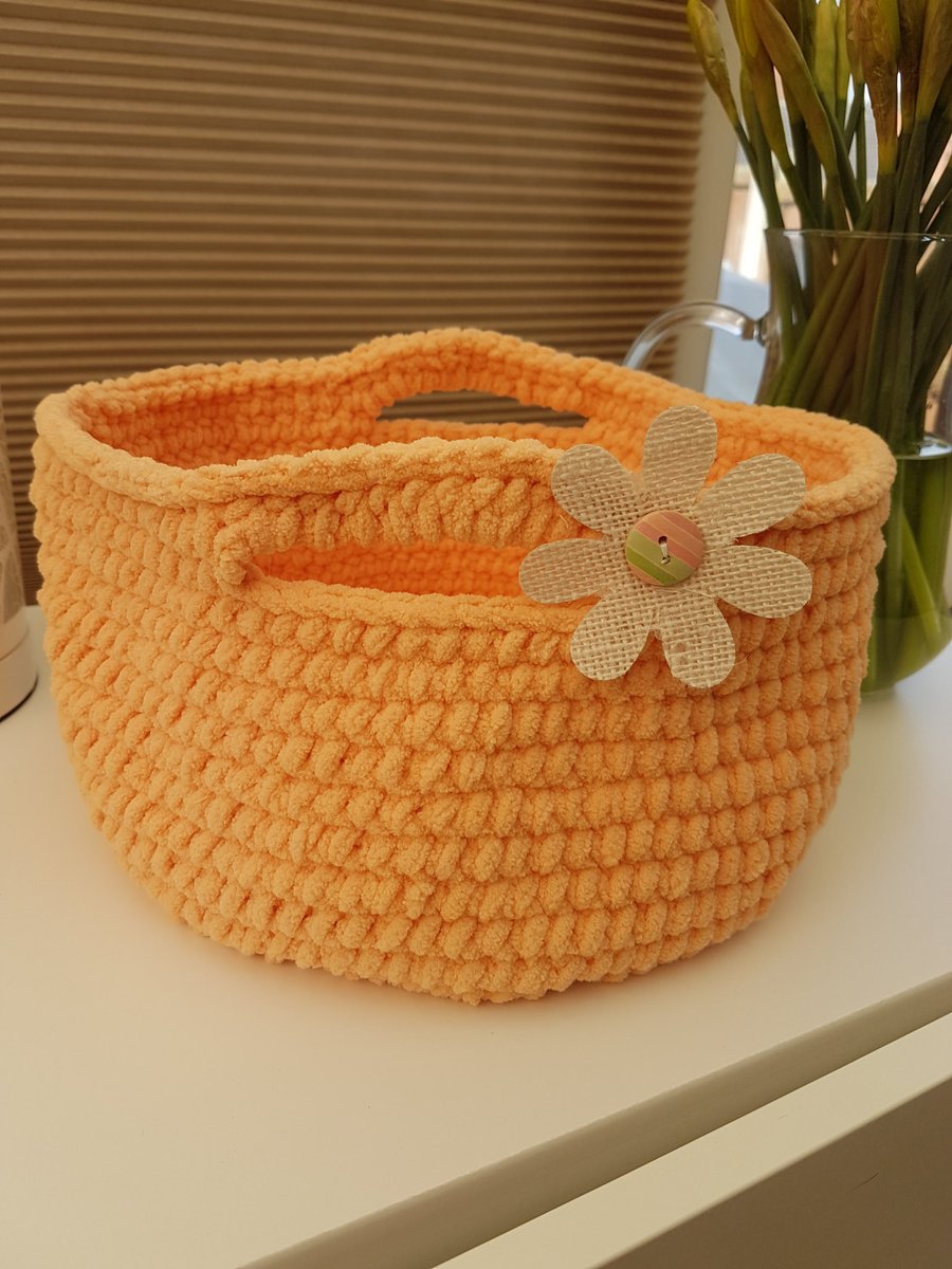 Peachy coral crocheted basket with a jute flower