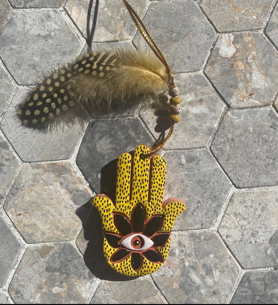 Small black and yellow hanging Hamsa hand 