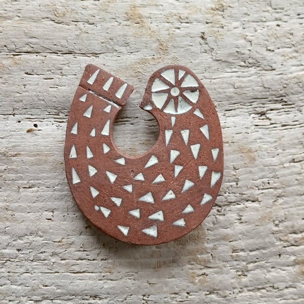 Red clay bird brooch. 