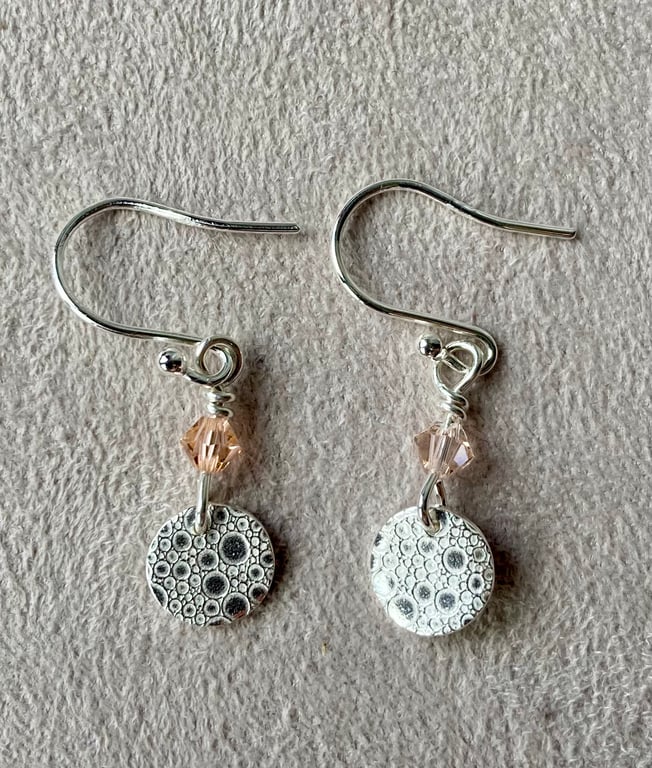 Circular silver earrings with bubble pattern and pale pink Swarovski crystals 