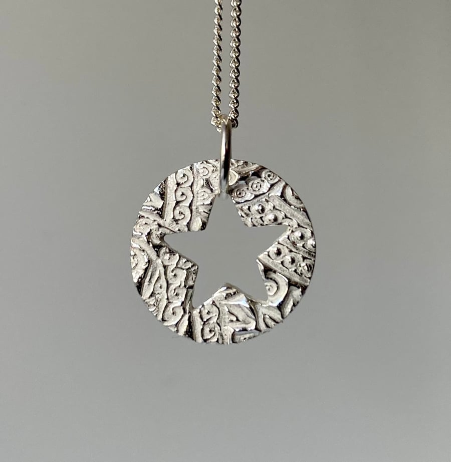 Pretty, circular necklace with lovely texture and cut out star. 