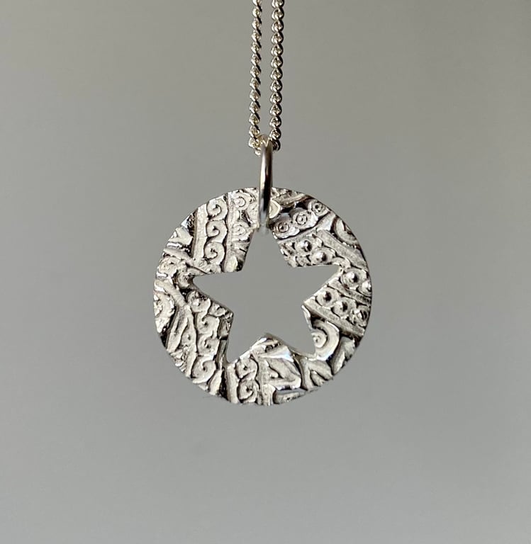 Pretty, circular necklace with lovely texture and cut out star. 