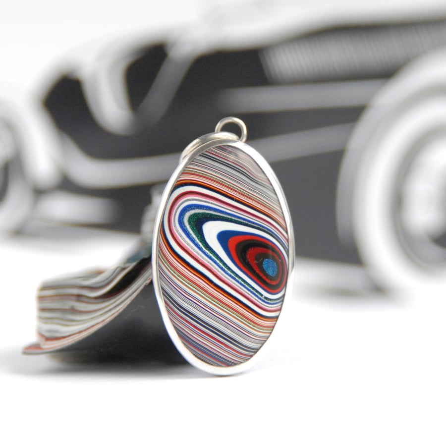 Oval Kenworth fordite pendant (red and black eye)