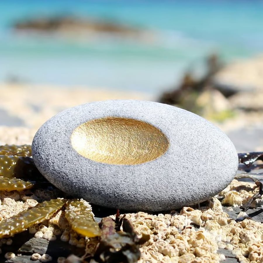Pebble pendant with golden recess, designed by contemporary jeweller John Field.