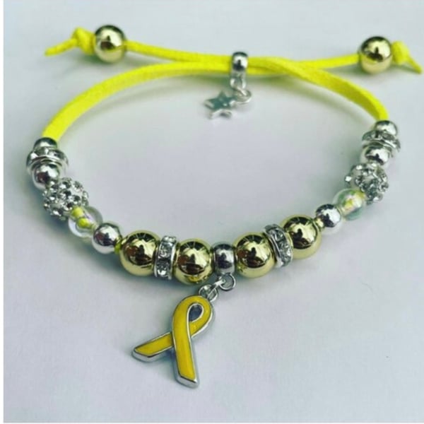 Yellow ribbon charm suede effect corded adjustable fit bracelet in awareness