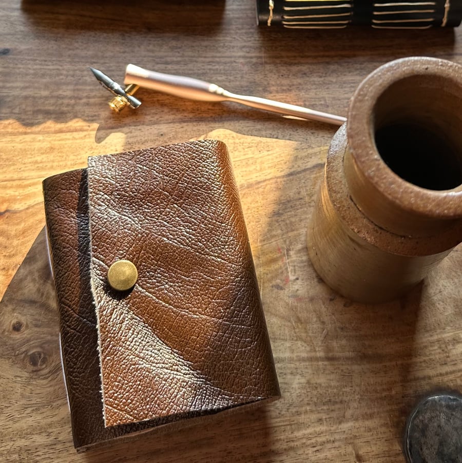 Up-cycled soft Leather long stitch pocket journal, 93 page, bronze snap closure.
