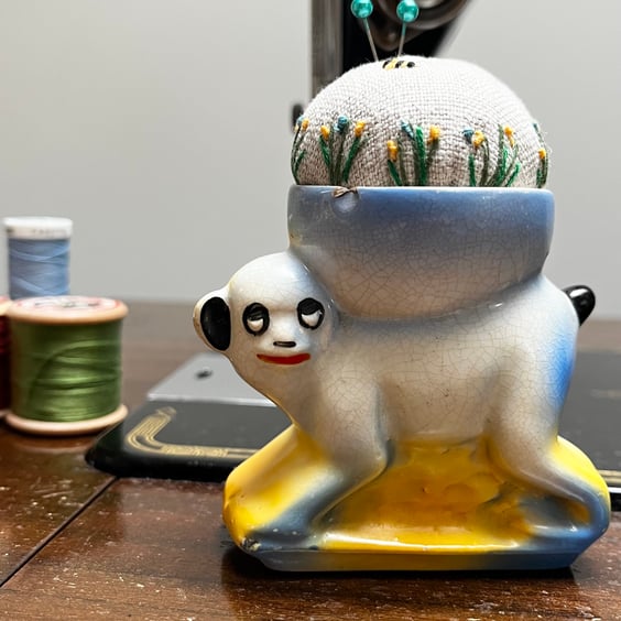 Pin cushion in a vintage monkey egg cup embroidered flowers and bee