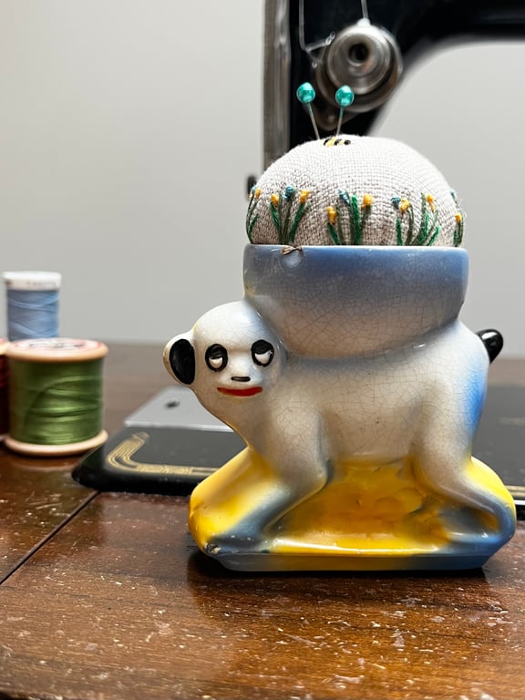 Pin cushion in a vintage monkey egg cup embroidered flowers and bee
