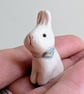 White bunny rabbit with forget me not flower ceramic figurine 