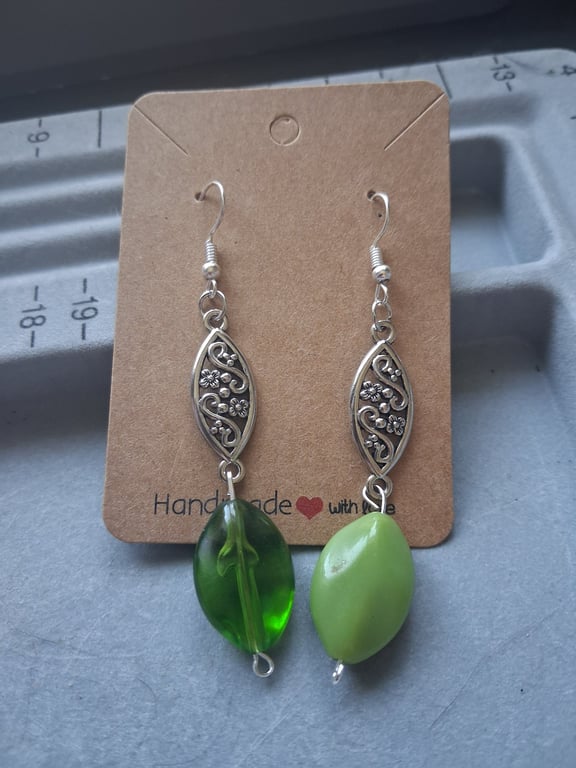 silver and green mismatched drop earrings