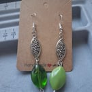 silver and green mismatched drop earrings