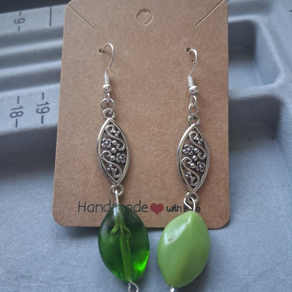 silver and green mismatched drop earrings