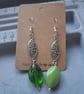 silver and green mismatched drop earrings