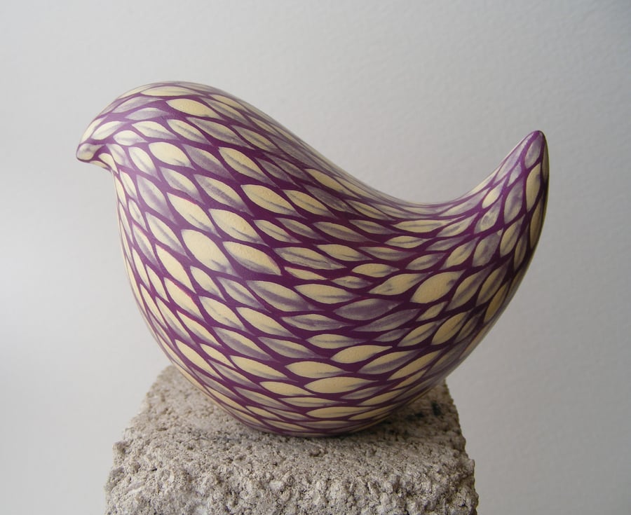 Painted bird (E) cream on blackberry