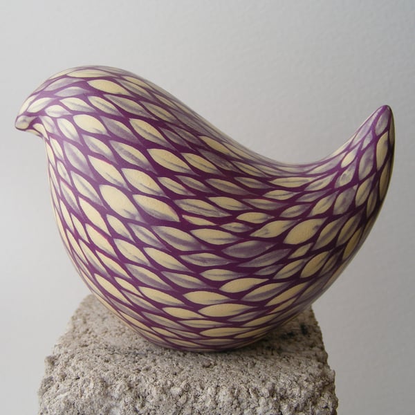 Painted bird (E) cream on blackberry