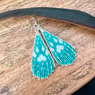 White wolf Southwestern inspired paw print fringe earrings in turquoise blue