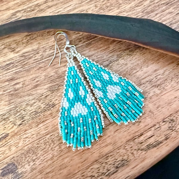 White wolf Southwestern inspired paw print fringe earrings in turquoise blue