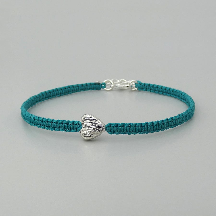 Teal 7" macramé bracelet with silver plated heart charm and 1” extender chain.