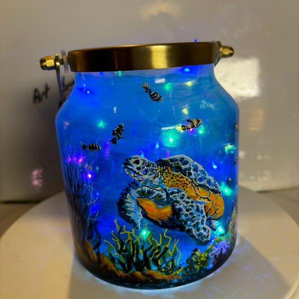 A hand painted and fired brass and glass lantern by Andrew Jenkins 