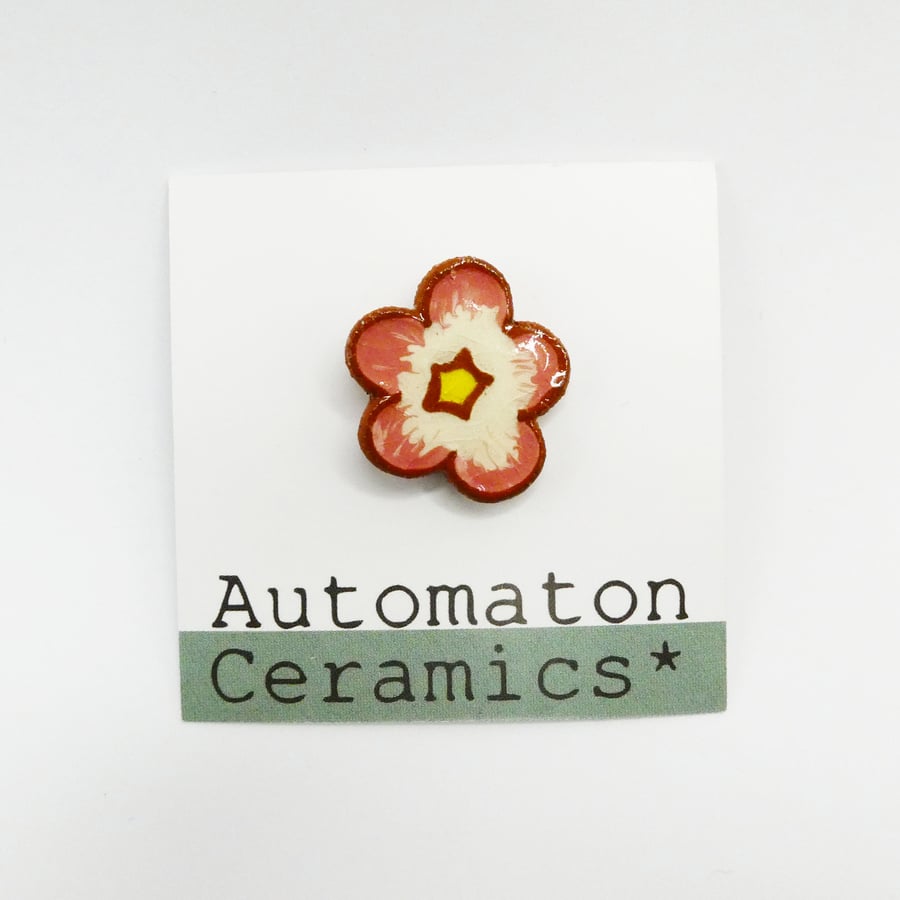 Flower ceramic pin badge.