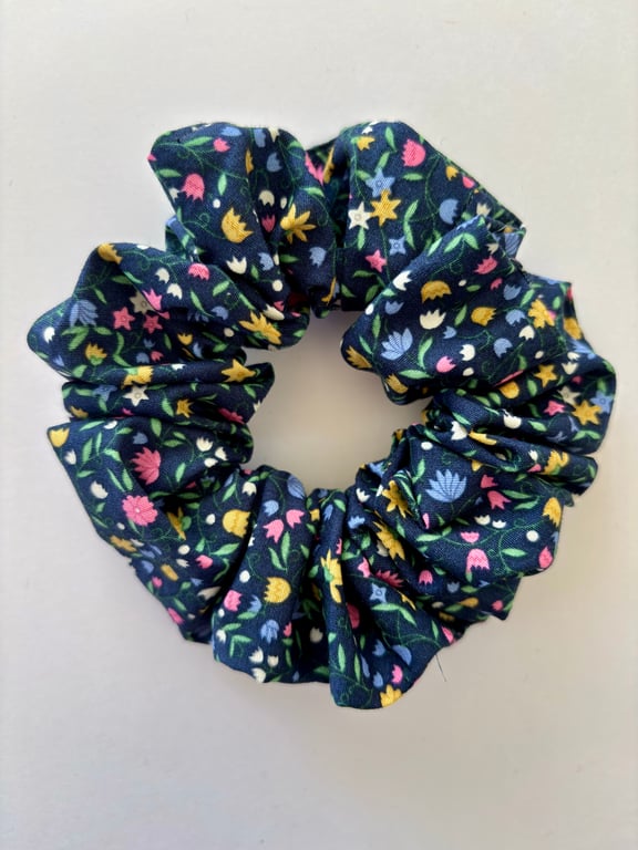Cotton scrunchie hair accessory in navy with a fun print of bright flowers