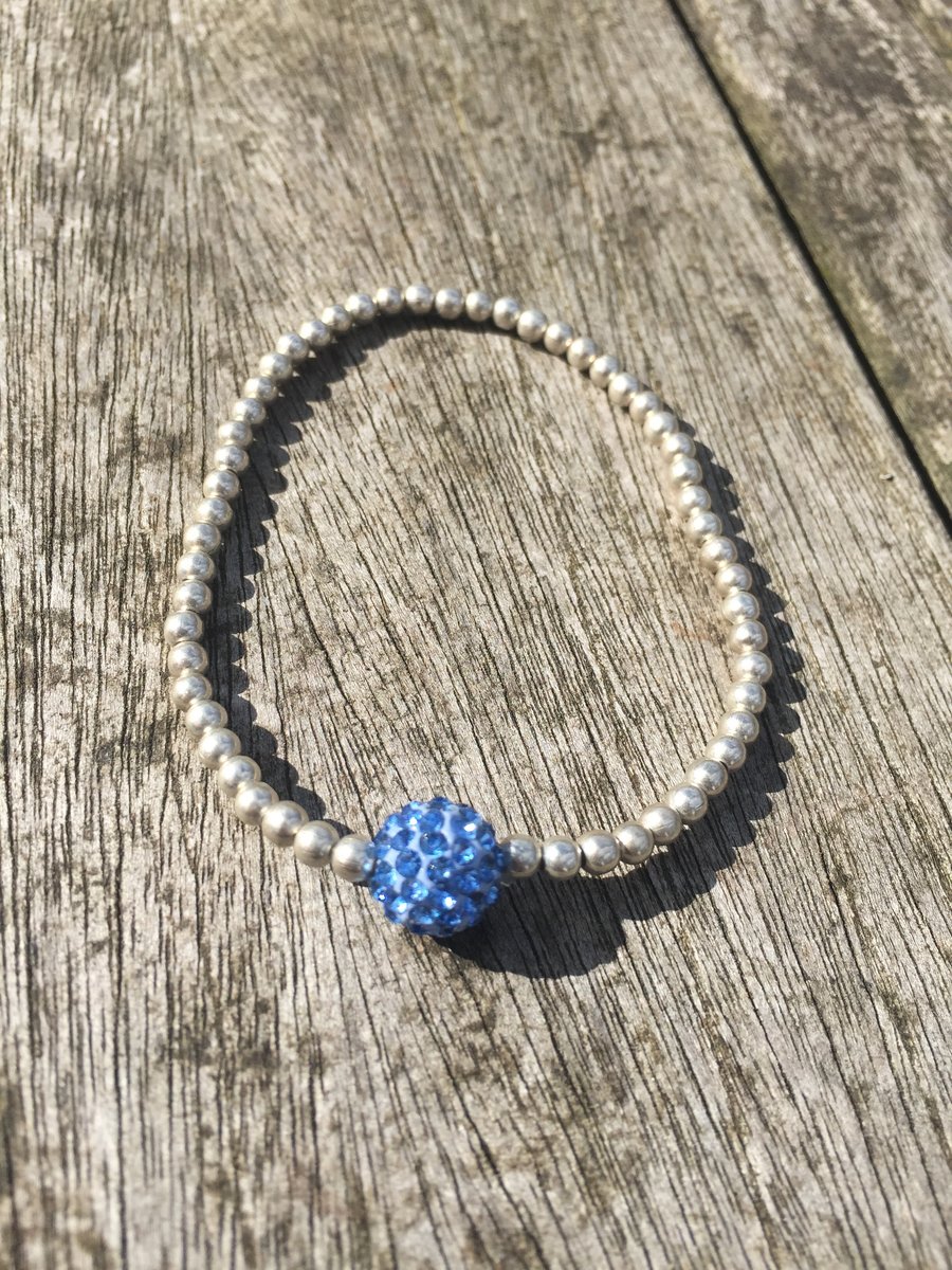 Elasticated silver plated metal beads and baby blue shamballa bead bracelet